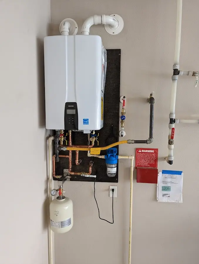 Professional plumber installing copper piping in a Lewistown home